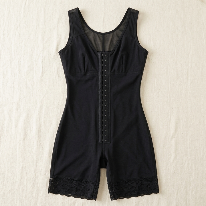 Black full-body shaper laid flat on a cream surface