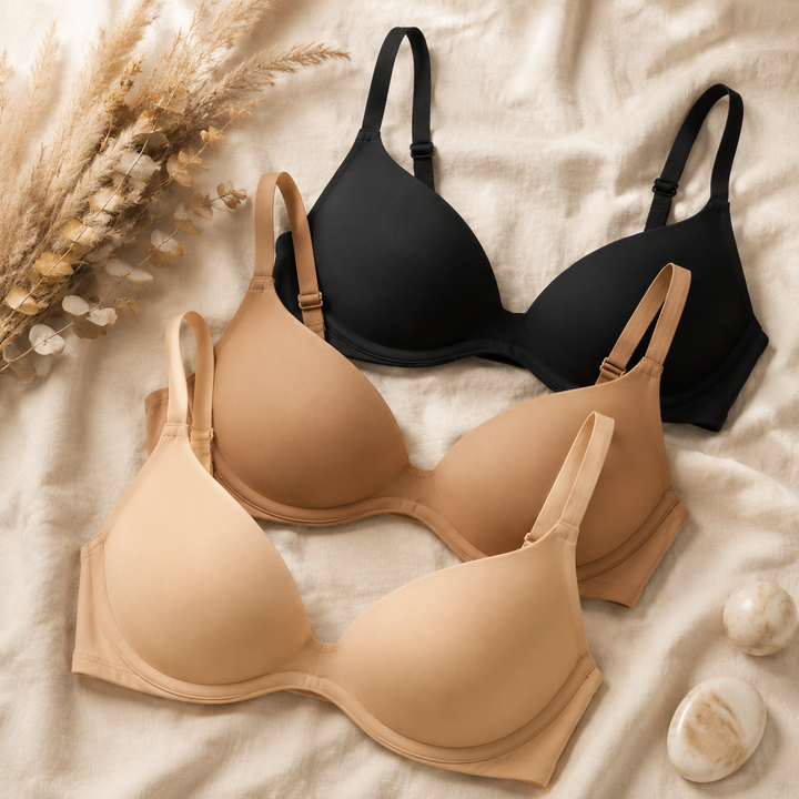 Nude and black unlined plunge bras laid flat on linen