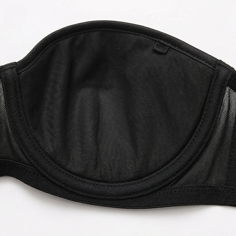 Black strapless bra laid flat to show the mesh cups
