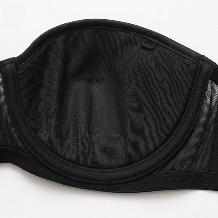 Black strapless bra laid flat to show the mesh cups