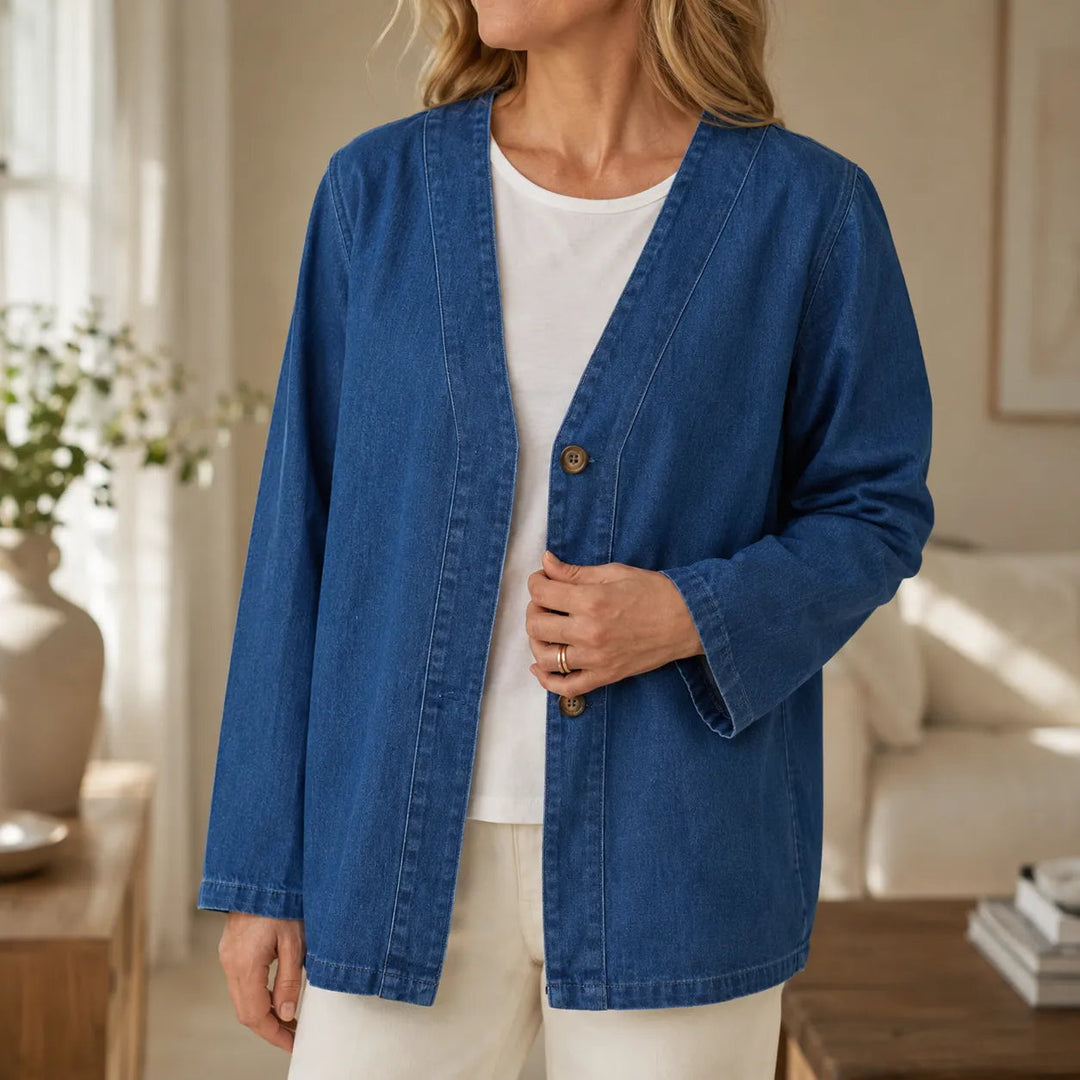 Collarless denim look jacket worn open over a white top