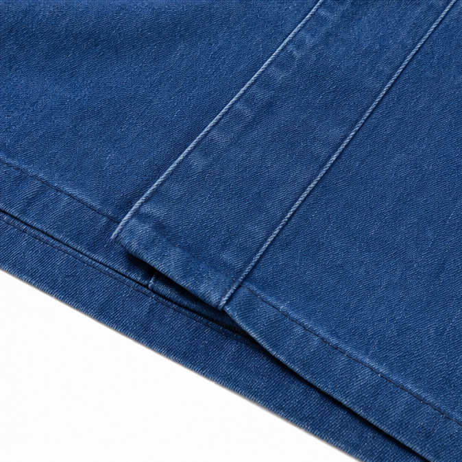 Topstitched hem and side seam on a blue denim look jacket