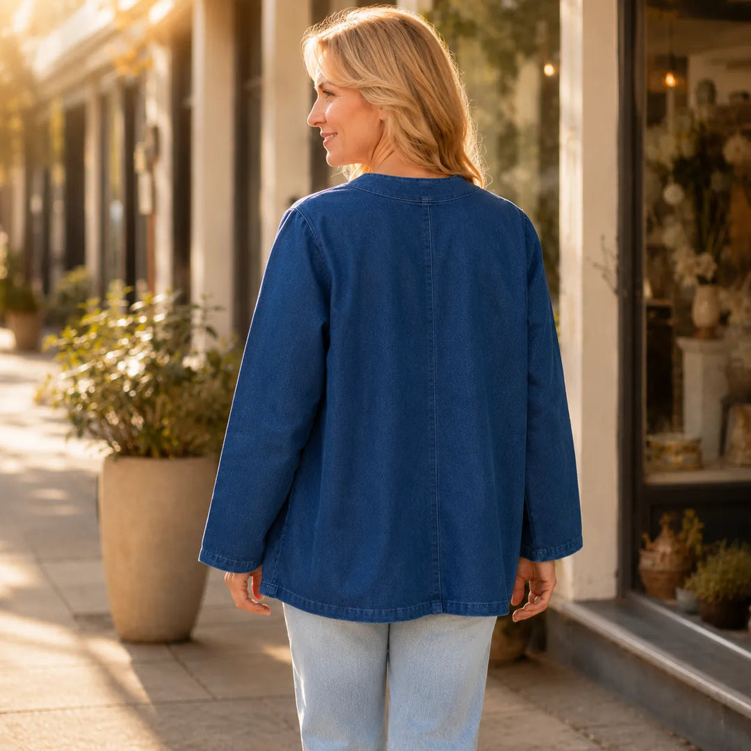 Back view of a collarless denim look jacket on a street
