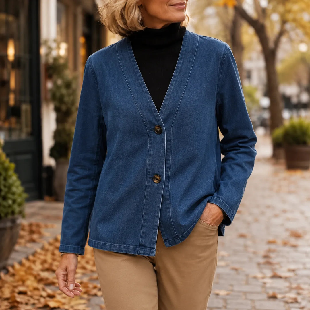 Denim look V neck jacket worn over a black turtleneck