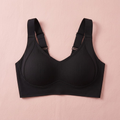 Black ribbed wireless bra laid flat on a pink background