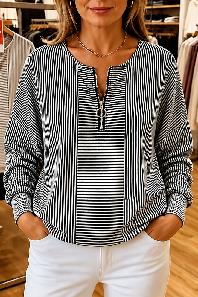 Black and white striped quarter zip top with a contrast panel