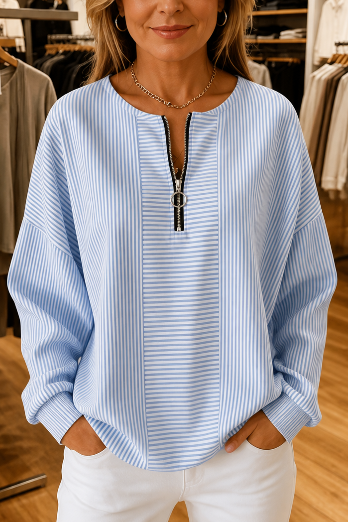 Light blue striped quarter zip top with a contrast panel