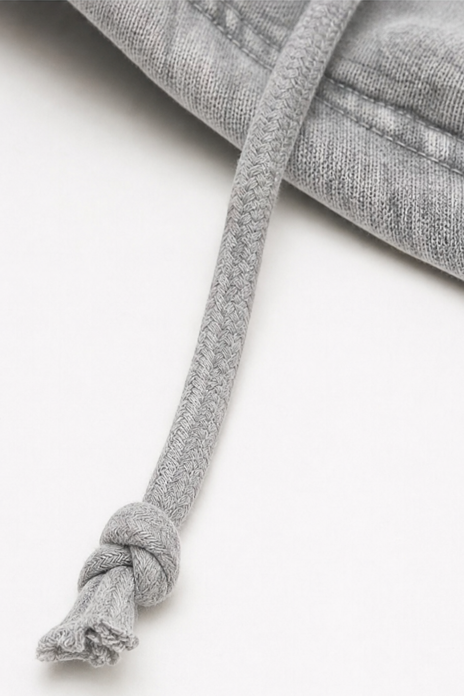 Knotted drawstring detail on a washed grey hoodie