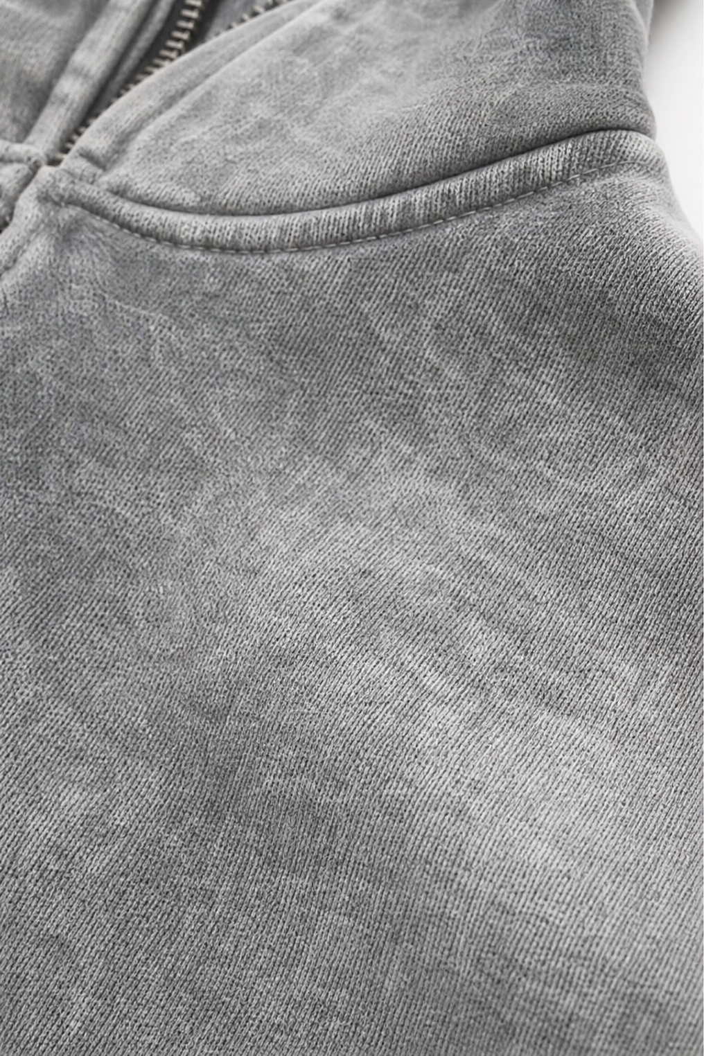 Close up of the washed grey fleece and pocket seam