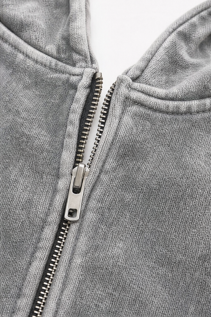 Metal zip and hood opening on a washed grey hoodie