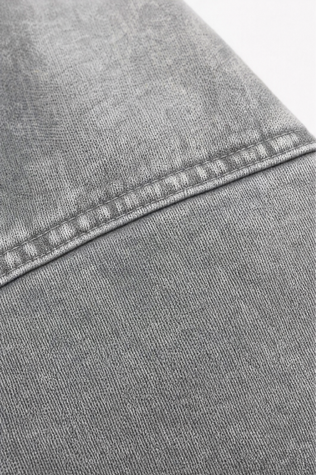 Topstitched shoulder seam on a washed grey hoodie