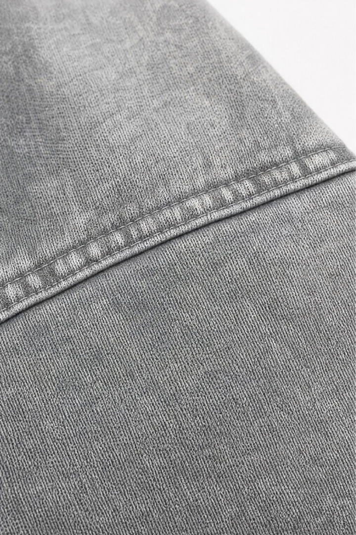 Topstitched shoulder seam on a washed grey hoodie