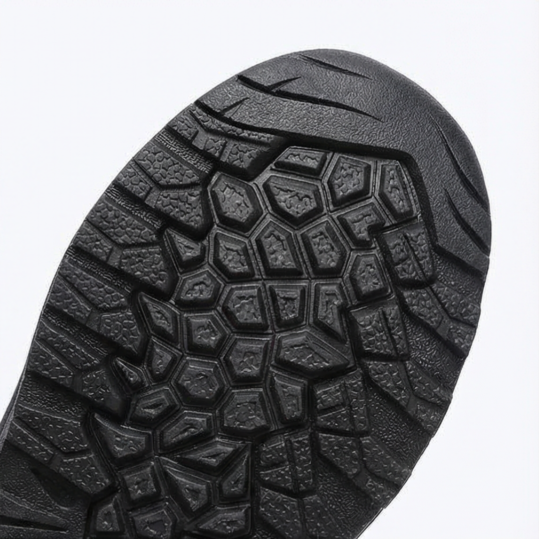 Close-up of the black lugged rubber outsole of a winter boot
