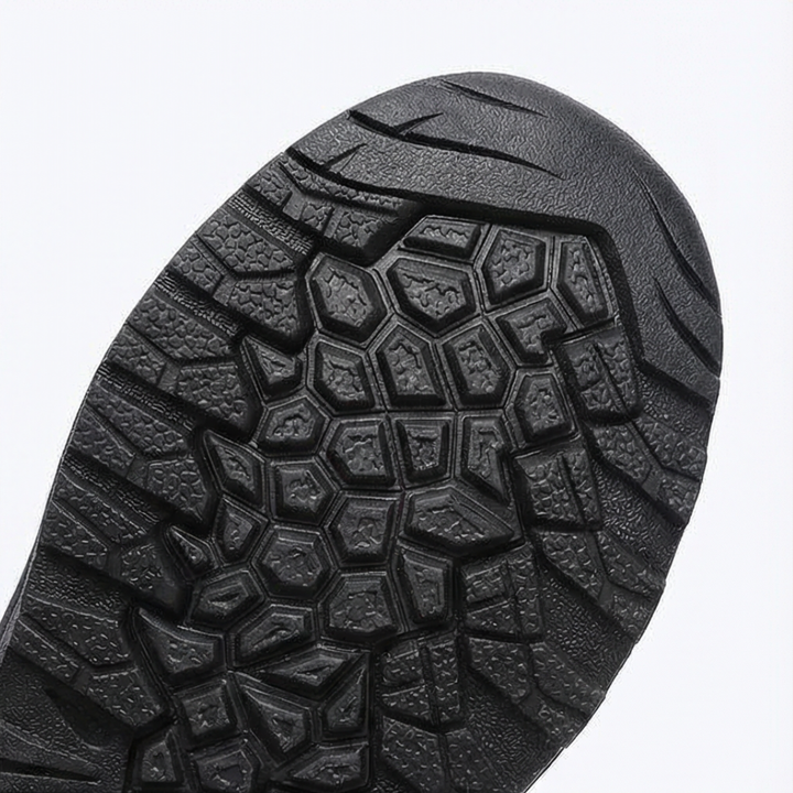 Close-up of the black lugged rubber outsole of a winter boot