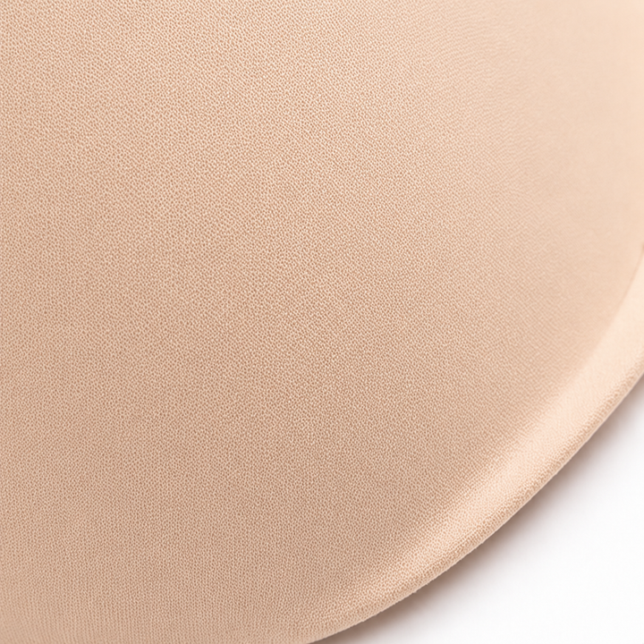 Close-up of the smooth moulded cup on a beige balconette bra