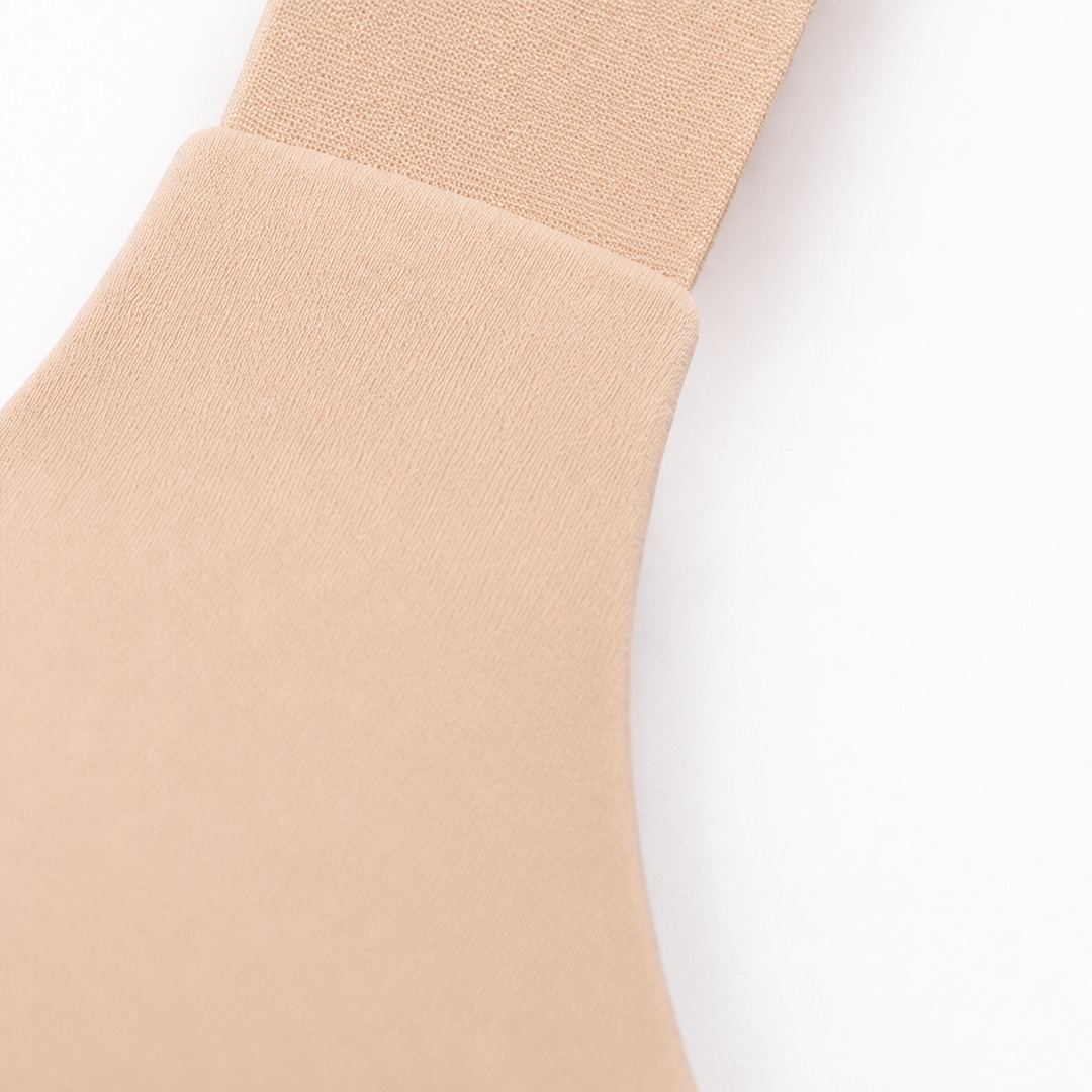 Close-up of a wide-set strap joining the band on a beige balconette bra