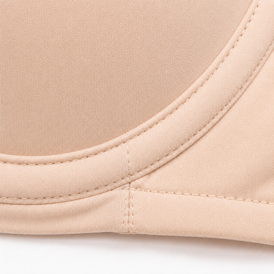 Close-up of the underwire seam along the cup edge of a beige balconette bra