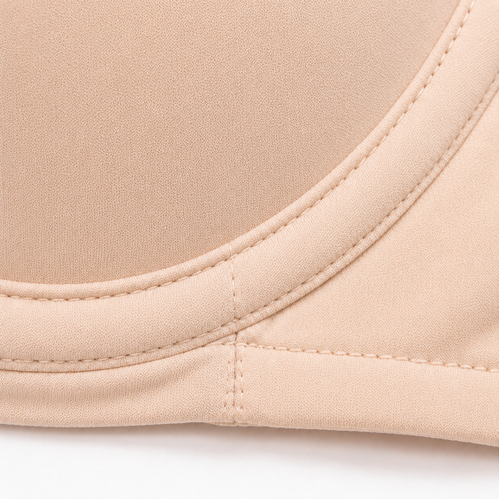 Close-up of the underwire seam along the cup edge of a beige balconette bra