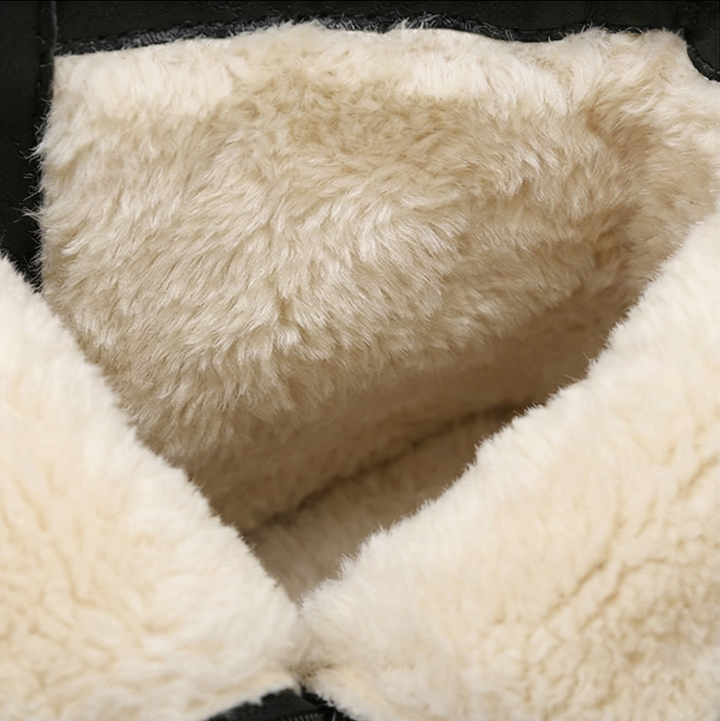 Close-up of the thick cream wool lining inside a black lace up boot