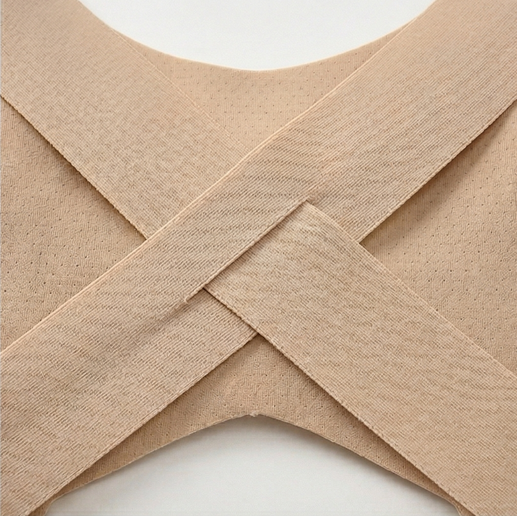 Close-up of the crossed X back straps on a nude bra
