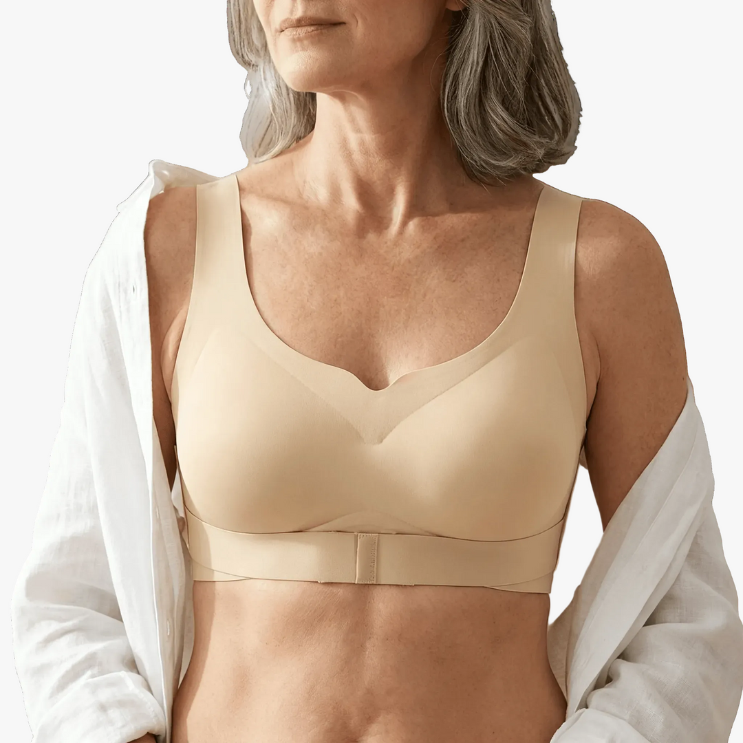 Nude X-back posture bra worn under an open white shirt