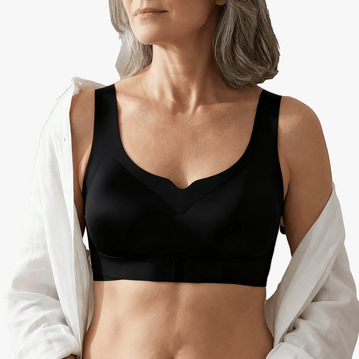 Black front-close posture bra worn under an open white shirt